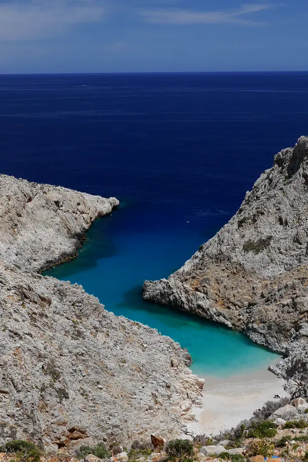 Coastal view and clear turquoise waters at Seitan Limania, a picturesque bay on the Cretan coast.